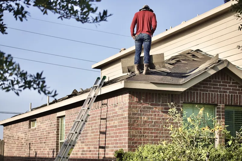 Professional roofer working on a residential roof in Guthriesville